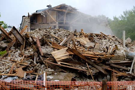 destroyed buildings which were some fragments in the background is visible part of the remaining building of which the wall fell, the destruction of housesの写真素材