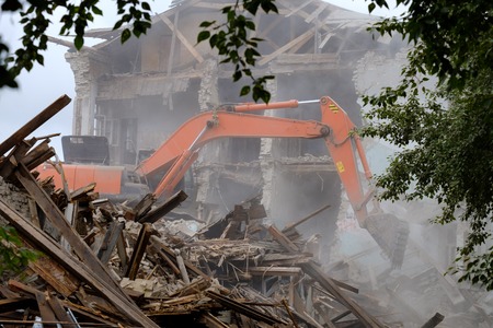 the equipment works on dismantling of the building, dust and debris from the structureの写真素材