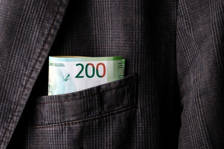 bill 2000 rubles in the pocket of a man's jacket, money in the pocket