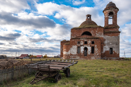 abandoned ruined Church in the countryside nearby is a horse cart, Sunny summer day sky with cloudsの写真素材