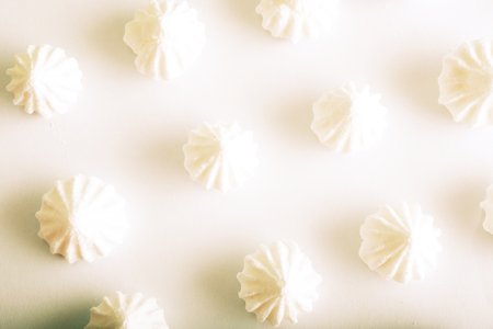 meringue cake white on a white background lined in a row, three rows of cakesの写真素材