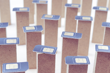 SIM cards on pillars standing on a white background, rows of pillars in SIM cards, cellular