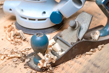 electro sander and manual old plane on a wooden surfaceの写真素材