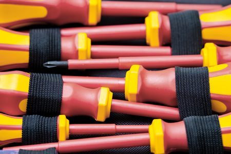 a set of screwdrivers red-yellow color lying in the case, a professional tool