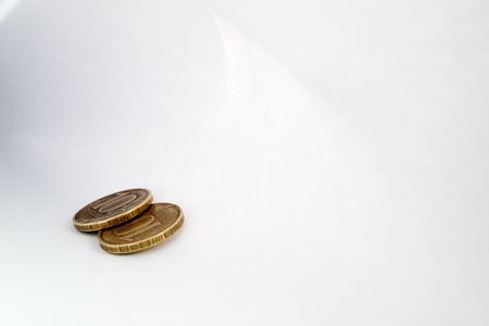 two copper coins lying on a sheet of white paper light shadow and light around the perimeter, Russian rublesの写真素材