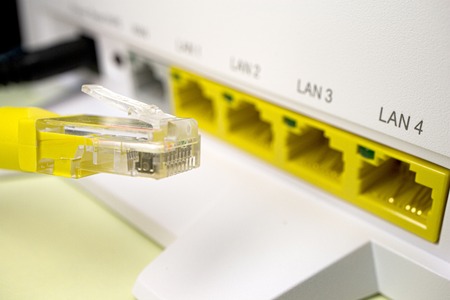 yellow twisted pair patch cord for Internet router white, and yellow connectorsの写真素材