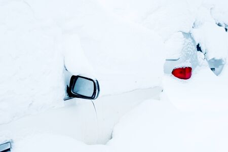 car under a thick layer of snow can be seen mirrorの写真素材
