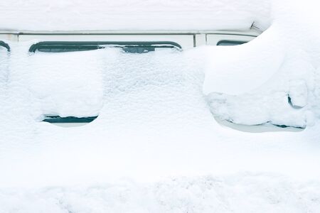 a minibus covered with snow are visible only to the side of the glass, not to leave a lot of snowの写真素材