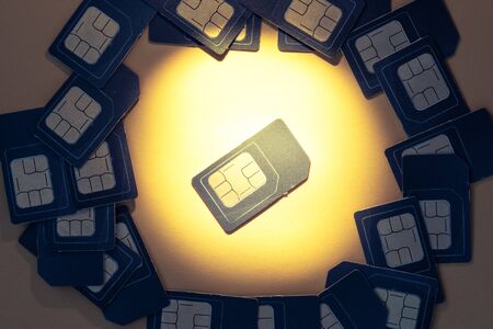 SIM card dedicated light beam, SIM card for phone surrounded by other SIM cardsの写真素材