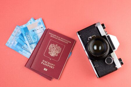 old camera and two passports on the background, the money can be seen from under the passportの写真素材