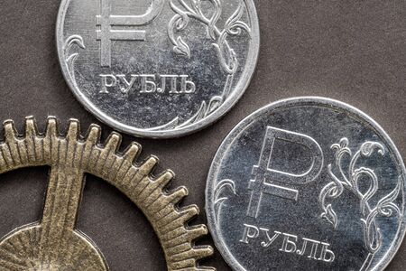 coins and gear as a symbol of the ruble exchange rate adjustment in the Russian economyの写真素材