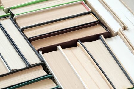 books are leaning against each other with different color covers top and side view