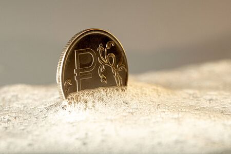 metal coin ruble with a symbol on the front of the foam solution. the concept of money laundering in the Russian economyの写真素材