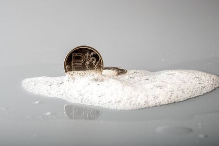 on the grey surface foam which is visible from the coin. washed the coin looks like newの写真素材