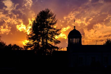silhouette of the tower with columns old architecture historical monument in Kamensk-Uralsky Russia Sverdlovsk region. sunset sky and bright orange cloudsの写真素材