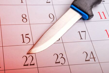 knife on the calendar gradient tinted red. plan a murder with a knife
