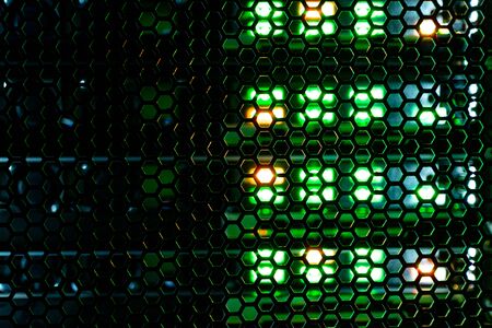 hexagonal mesh texture of metal behind which the indicator lights of the equipment. abstract...