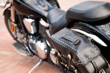 leather bag with metal rivets on the back of the motorcycle. motorcycle in the Parking lot while travelingの写真素材