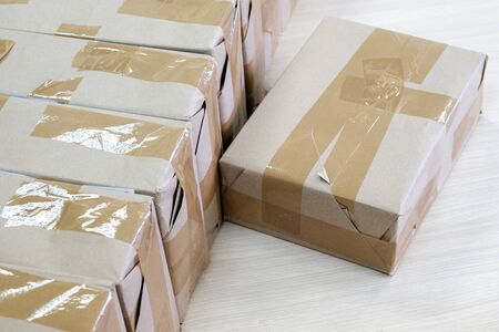 the sealed box is next to the other boxes. sort the batches in the warehouse