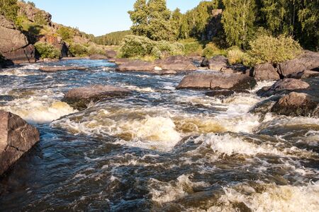 mountain river the flow of water rapidly creates foam and waves large stones skirting