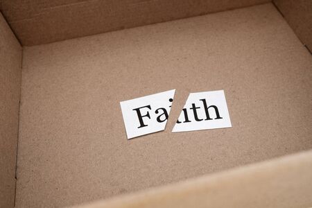 cut the word faith in an open box of beige color. a package came with a circumcised faithの写真素材