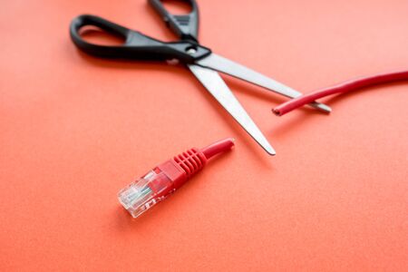 scissors cut the Internet cable into two parts. Internet will no longer be free from Internet addictionの写真素材