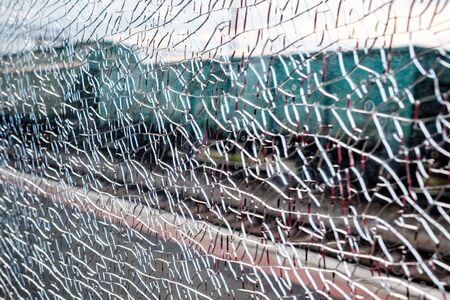 broken glass in the cabin of the car on the railway in small cracks. hooligans broke the window of...