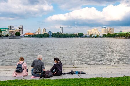 Russia, Yekaterinburg, August 14, 2019 vacationing tourists on the embankment of the city pond on the Iset river in Yekaterinburgの写真素材