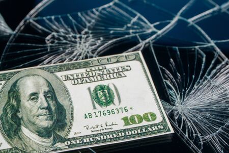 not real one hundred dollars against broken glass. dollar crashの写真素材