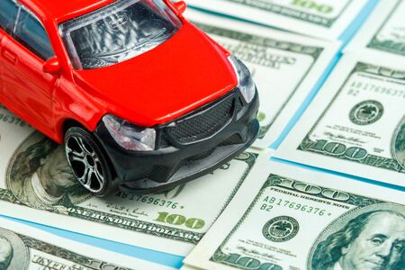 front of a red car on dollar bills. car saleの写真素材