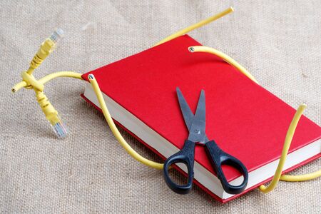 scissors cut the cable Internet enveloped the book. paper books free from internet addiction
