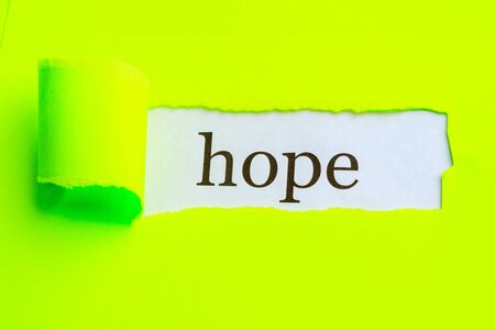 hope is written on the surface from under torn light green paper. hope opened upの写真素材
