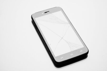 Fallen smartphone crashed screen on a gray background. glare-free lighting