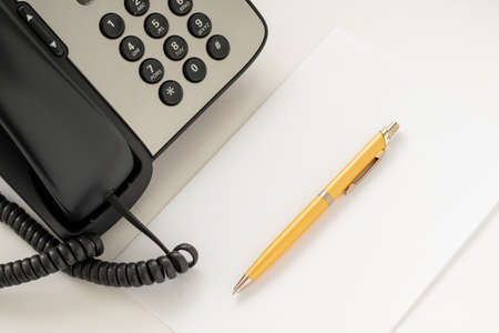fountain pen and phone tools of a call center employeeの写真素材