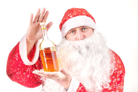 santa claus is holding a bottle of alcohol in his hand, this is a gift to those who will celebrateの写真素材