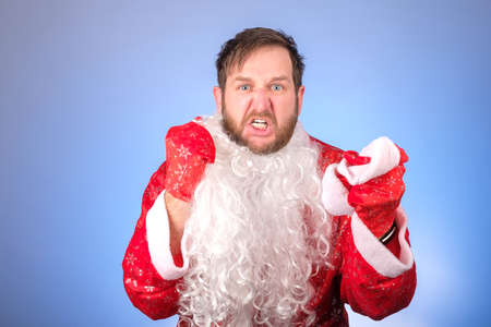 angry man angry clenched fists, tired of new year and christmas. aggression after the holidaysの写真素材