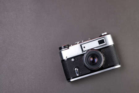 old film camera silver color on black background paper textureの写真素材
