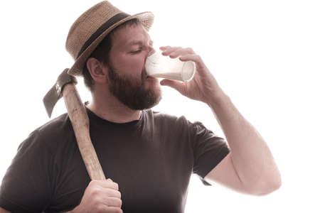 village man with an ax and a hat drinking milk background white. even brutal men drink dairy...