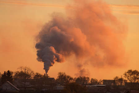 smoke from the chimney over the silhouette of the village, harmful smoke
