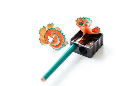 pencil sharpener with shavings on white sheet of paper, pencil sharpening processの写真素材