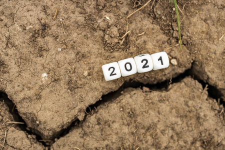 2021 numbers on a cube near a crack in the ground. symbolism of tragedy in the year