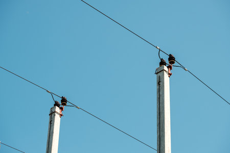 electrical wires on poles against the sky. concrete poles and cableの写真素材