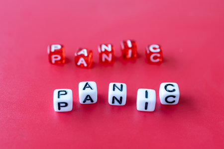 on a red background with cubes on which panic is written. white and red cubesの写真素材