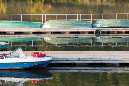 boat with lifebuoy at the stern, out of focus background boats for rentの写真素材