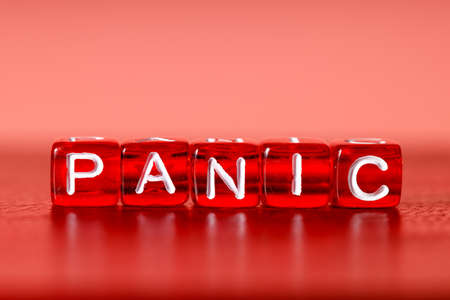 panic close-up on red plastic molds. red background and color of panic moodの写真素材