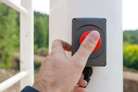 frontal view of the finger that presses the call button. ski warning system in summer