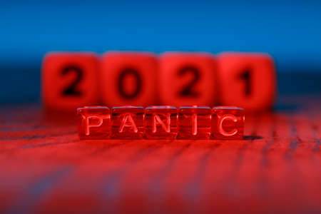 alarming red color and cubes with the words Panic on the background of the year 2021. troubled year,...