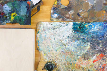 flatley top view on artist's objects palette for mixing paints and wooden surface