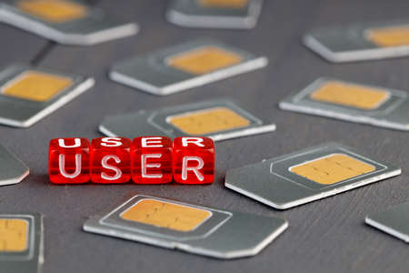 red cubes with the inscription user around the sim card cubes in large quantitiesの写真素材