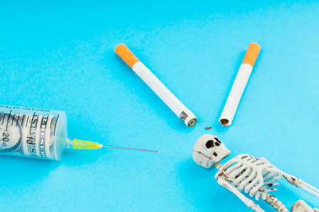 a human skeleton, a needle from a syringe and a cigarette fit his skull, a rolled dollar was put...